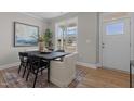 Bright dining area with a modern black table set, large window, and stylish decor at 30 Diamond Creek Dr, Zebulon, NC 27597