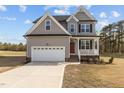 Charming two-story home with a well-manicured lawn, a two-car garage, and a classic architectural design at 30 Diamond Creek Dr, Zebulon, NC 27597