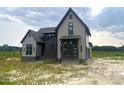 Charming two-story home with gray siding and dark accents, nestled on a spacious lot, ready for landscaping at 4905 Hidden Pasture Way, Zebulon, NC 27597