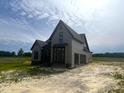 New construction home featuring an attached garage, board and batten siding, and black windows at 4905 Hidden Pasture Way, Zebulon, NC 27597