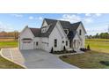 This stunning home boasts a manicured lawn, a three-car garage, and a welcoming covered front porch at 4909 Hidden Pasture Way, Zebulon, NC 27597
