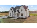 A gorgeous home complete with a manicured lawn, a covered front porch, and lush landscaping at 4909 Hidden Pasture Way, Zebulon, NC 27597