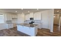 Modern kitchen with white cabinets, granite countertops, and an island at 829 Emmer St, Rolesville, NC 27571