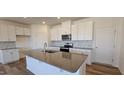 Modern kitchen with white cabinets, granite countertops, and an island at 829 Emmer St, Rolesville, NC 27571