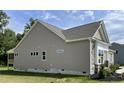 Side view of the home showcasing the siding, windows, and landscaping at 69 Browning Mill Dr, Wendell, NC 27591