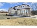 Gray house with stone accents, landscaped lawn, and a welcoming front porch at 55 Browning Mill Dr, Wendell, NC 27591