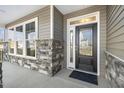 Modern front entrance with a black door and stone accents at 55 Browning Mill Dr, Wendell, NC 27591