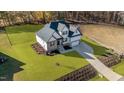 Stunning new construction showing craftsman-style home with a lush green lawn and a concrete driveway at 148 Hook Dr # 7, Fuquay Varina, NC 27526