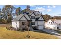 Charming two-story home with stone and siding exterior, lush lawn, and mature trees at 148 Hook Dr # 7, Fuquay Varina, NC 27526