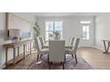 Bright dining room with natural light, featuring a modern table, seating for six, and elegant decor at 65 Diamond Creek Dr, Zebulon, NC 27597