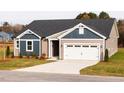 Two-toned home with white garage door and landscaping at 7409 Prato Court, Wendell, NC 27591