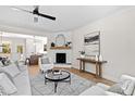 Bright living room featuring a fireplace with modern decor, plush seating, and hardwood floors at 108 Nakoma Dr, Louisburg, NC 27549