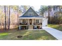 Beautiful two-story home boasts a cozy front porch and lush green lawn at 158 Nakoma Dr, Louisburg, NC 27549