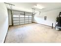 Spacious two-car garage with automatic door opener and clean concrete flooring at 114 Southern Estates Dr, Sanford, NC 27330
