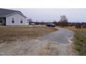 Long paved driveway leading to a single-Gathering home at 1850 Gillburg Road, Henderson, NC 27537