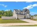 Attractive two-story home with a well-manicured lawn, an attached two-car garage, and a white picket fence at 9113 Dupree Meadow Dr # 41, Angier, NC 27501