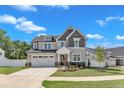 Lovely two-story home featuring a manicured lawn, stone accents, and an attached two-car garage at 9113 Dupree Meadow Dr # 41, Angier, NC 27501