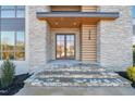 Modern front entry with stone facade and double doors at 9009 Meadow Pointe Ct, Wake Forest, NC 27587
