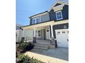 Two-story home featuring gray siding, white trim, and a covered porch at 836 Challenger Ln, Knightdale, NC 27545