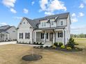 Inviting two-story home with a covered entry, complemented by manicured landscaping at 110 Summerlin Dr, Clayton, NC 27527