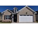 Two-story brick home with a white garage door at 190 Brunswick Dr, Nashville, NC 27856