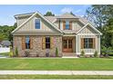 Attractive home featuring stone accents, vertical siding and a beautiful lawn at 112 Lambert Ln, Fuquay Varina, NC 27526