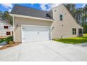 Attached two-car garage featuring a paved driveway and well-maintained exterior at 73 Artic Cir, Garner, NC 27529