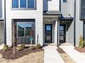 Close-up of modern townhouses, showcasing clean lines, neutral colors, and tidy landscaping for a welcoming curb appeal at 1156 Cottonsprings Dr, Wendell, NC 27591