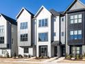 Stylish townhouses featuring a contemporary exterior design with manicured landscaping and a well-maintained lawn at 1156 Cottonsprings Dr, Wendell, NC 27591