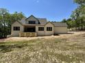 The backyard showcases a covered patio, large windows and a spacious yard at 316 Firefly Overlook, Pittsboro, NC 27312
