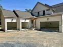 Spacious three-car garage with modern doors and matching exterior at 316 Firefly Overlook, Pittsboro, NC 27312