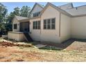 Rear exterior featuring ample windows and an inviting covered patio at 316 Firefly Overlook, Pittsboro, NC 27312