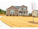 Charming two-story home boasting a lush front lawn and welcoming curb appeal at 4466 Debnam Rd, Zebulon, NC 27597