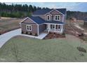 Stunning exterior of home with well-maintained lawn and cozy front porch at 4466 Debnam Rd, Zebulon, NC 27597