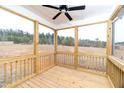 Relaxing screened-in porch features wood flooring, ceiling fan, and scenic views at 4466 Debnam Rd, Zebulon, NC 27597