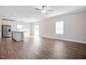Spacious living area with hardwood floors, natural light, and a view into the kitchen at 600 Rhino Bnd, Oxford, NC 27565