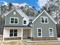 Living Room with wood-look floors, fireplace, and large windows at 83 Artic Circle, Garner, NC 27529