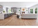 Bright and airy living room featuring a fireplace, hardwood floors, and stylish gray kitchen in an open layout at 154 Colonial Trail Ct, Pittsboro, NC 27312