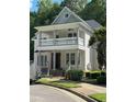 Two-story home featuring a covered porch, white railings, and support columns at 8305 Society Pl, Raleigh, NC 27615