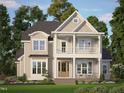 Charming home boasts a inviting porch, beautiful landscaping, and classic architectural details at 8305 Society Pl, Raleigh, NC 27615