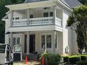 Two-story home featuring a covered porch, white railings, and support columns at 8305 Society Pl, Raleigh, NC 27615