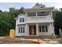 An in-progress exterior elevation of a home featuring a double porch with columns and detailed trim at 8305 Society Pl, Raleigh, NC 27615
