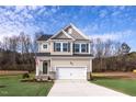 Two-story house with gray siding, white trim, and a two-car garage at 176 Van Winkle St, Lillington, NC 27546