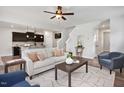 Bright open-concept living room featuring modern decor, ceiling fan, and hardwood floors at 176 Van Winkle St, Lillington, NC 27546
