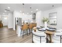 Beautiful eat-in kitchen features stainless appliances, island seating, and dining area with modern decor at 4015 Elk Creek Ln, Raleigh, NC 27612