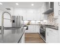 Modern kitchen featuring stainless steel appliances, ample cabinetry, and sleek countertops at 4015 Elk Creek Ln, Raleigh, NC 27612