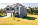 Two-story home with an attached garage, stone accents, and a lush green lawn at 592 Barbour Farm Ln, Four Oaks, NC 27524