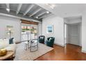 Bright living room featuring exposed ceiling, sliding glass doors, and stylish seating arrangement at 1300 St Marys St # 208, Raleigh, NC 27605