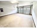Spacious and clean two-car garage with a white door and overhead lighting at 122 Southern Estates Dr, Sanford, NC 27330