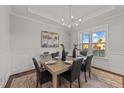 Formal dining room with hardwood floors, a chandelier, and large windows at 130 Summerlin Dr, Clayton, NC 27527